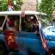 Участники митинга на старом внедорожнике с патриотической символикой на 77-ю годовщину Дня Победы в Воронеже. В 2022 году к символике праздника добавили знак военного вторжения в Украину – букву Z, напоминающую нацистского Вольфзангеля.